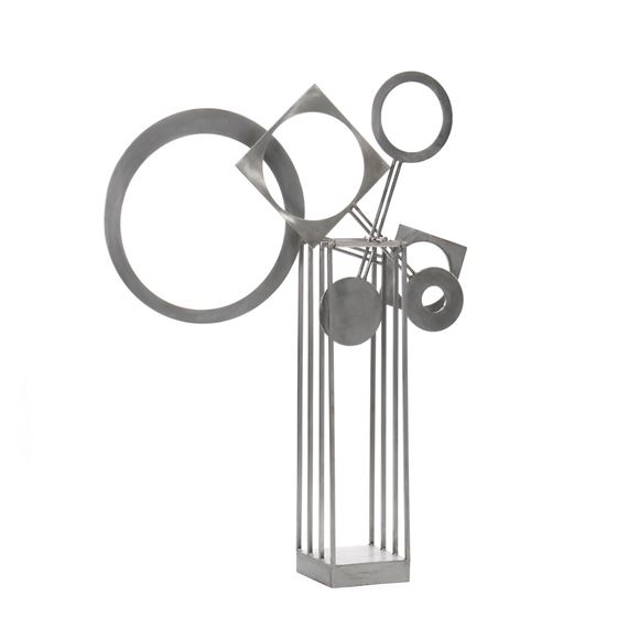 A minimalist metal sculpture featuring geometric shapes suspended over a vertical grid base.