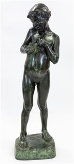 A bronze sculpture of a standing nude figure holding a small object.