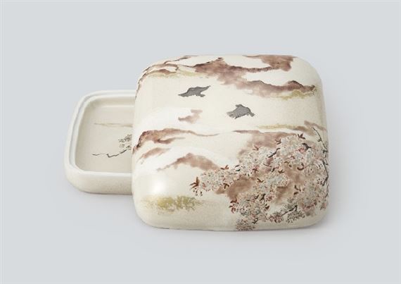 Yellow lidded container depicting spring clouds in gold and silver glaze