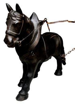 A dark, metallic sculpture of a horse in harness against a stark white background.