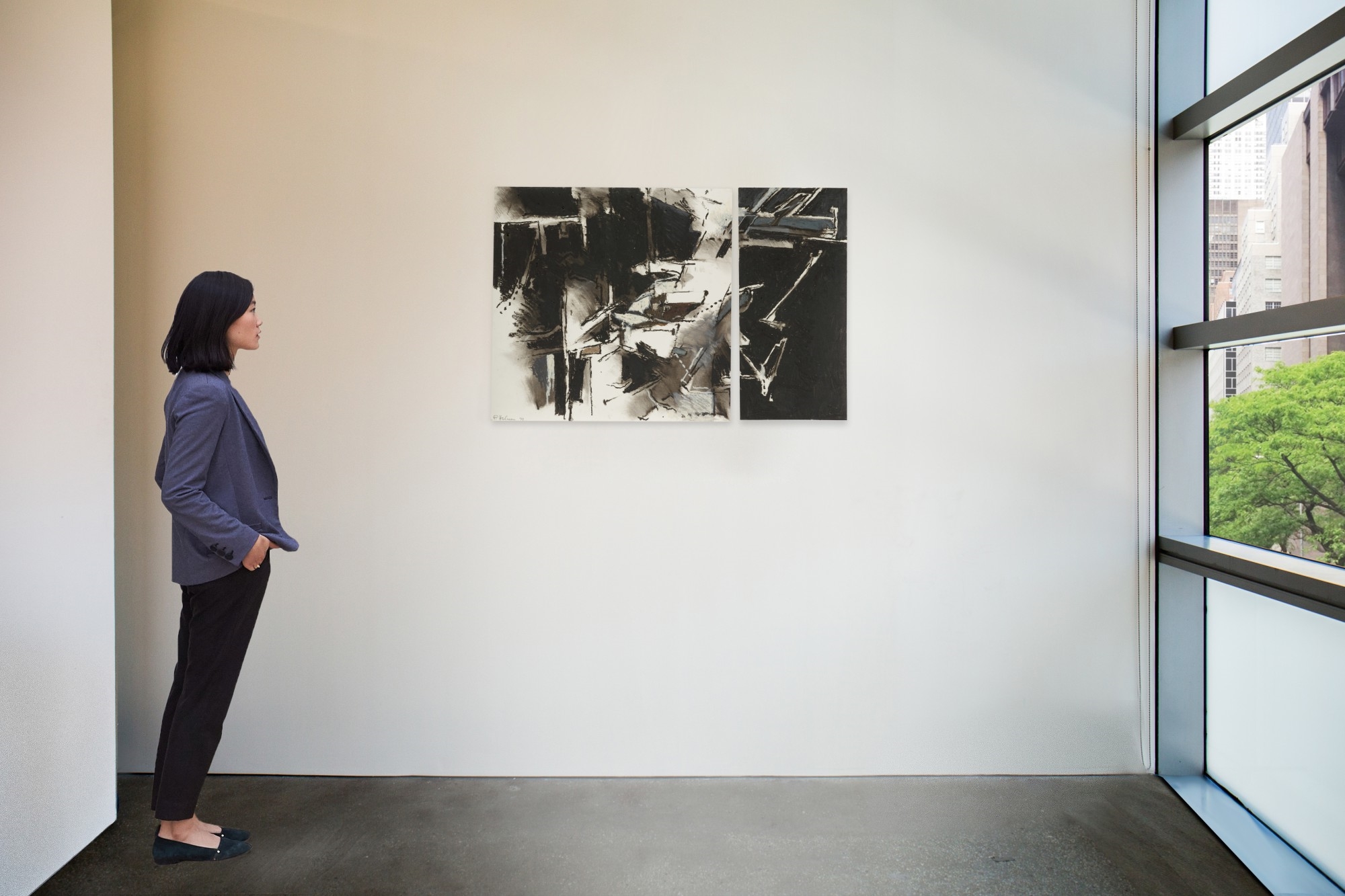 A diptych of abstract ink wash paintings featuring bold black shapes against white and grey backgrounds.