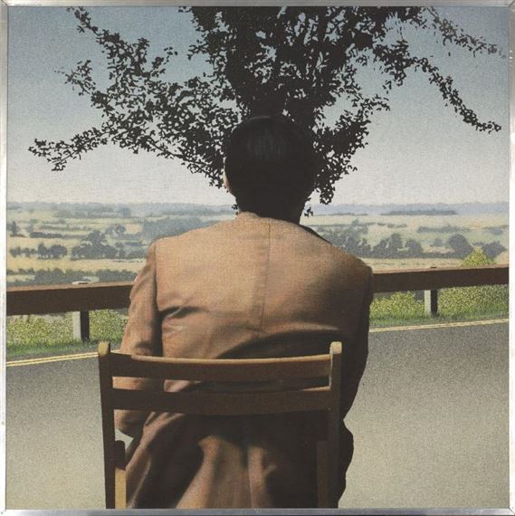 A solitary figure in a suit sits on a wooden chair, gazing out over a vast rural landscape under a tree.