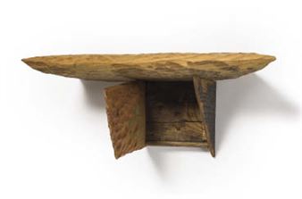 A rustic wooden shelf with a textured, leaf-shaped top and an open storage compartment.