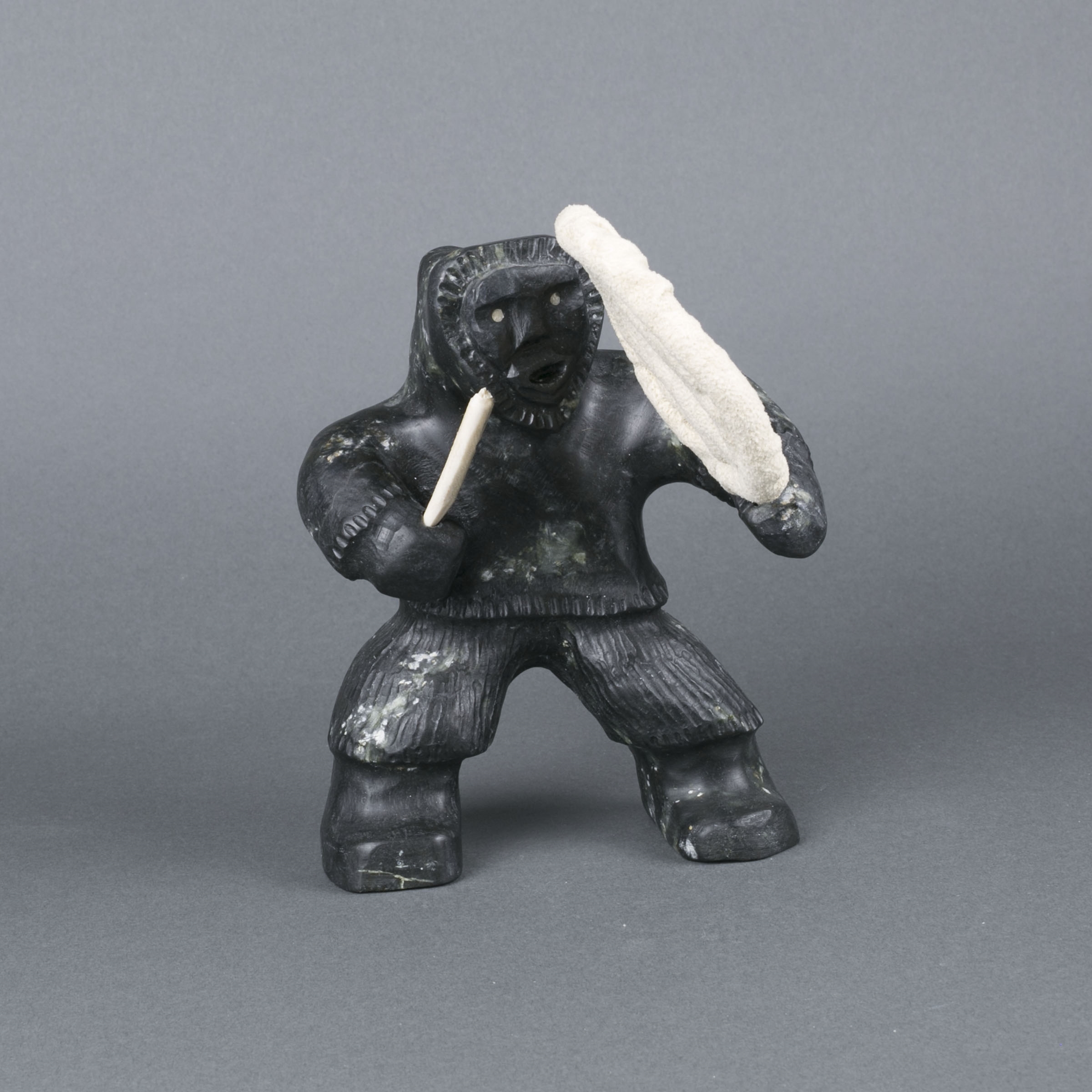 Artwork by Louis Mikkituq, DRUMMER, Made of bone, hide