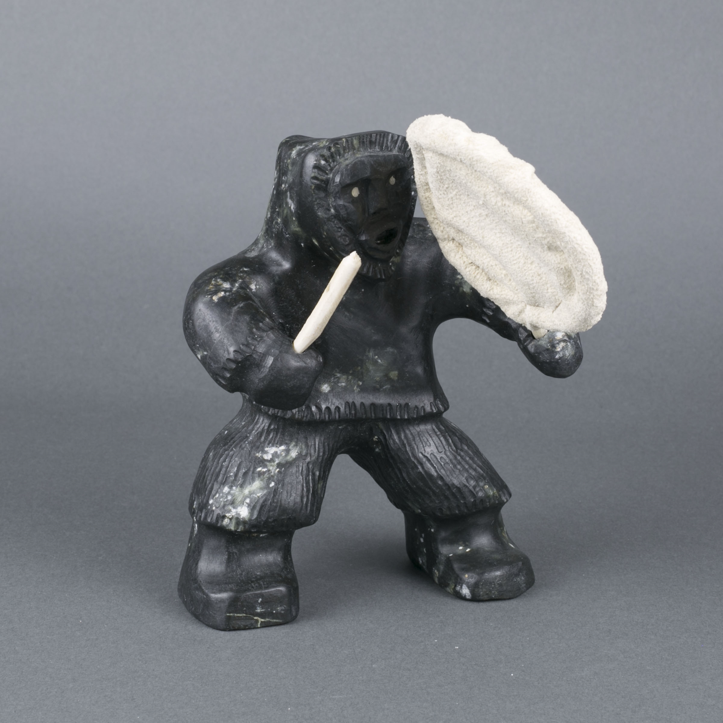 Artwork by Louis Mikkituq, DRUMMER, Made of bone, hide