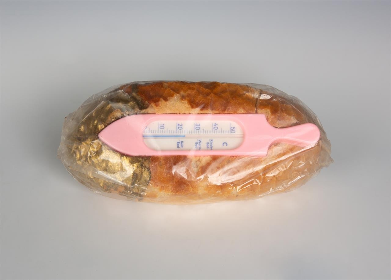 Artwork by Wolf Vostell, PRAGER BROT, Made of Wheat bread with an embedded bath thermometer, partially painted over with golden paint