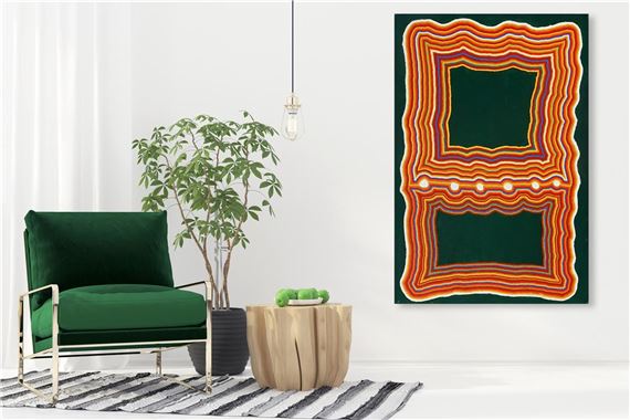 A modern interior scene featuring a green armchair, wooden side table, and abstract wall art.