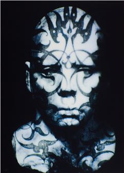 A monochromatic portrait of a person with intricate, swirling patterns covering their face and neck.