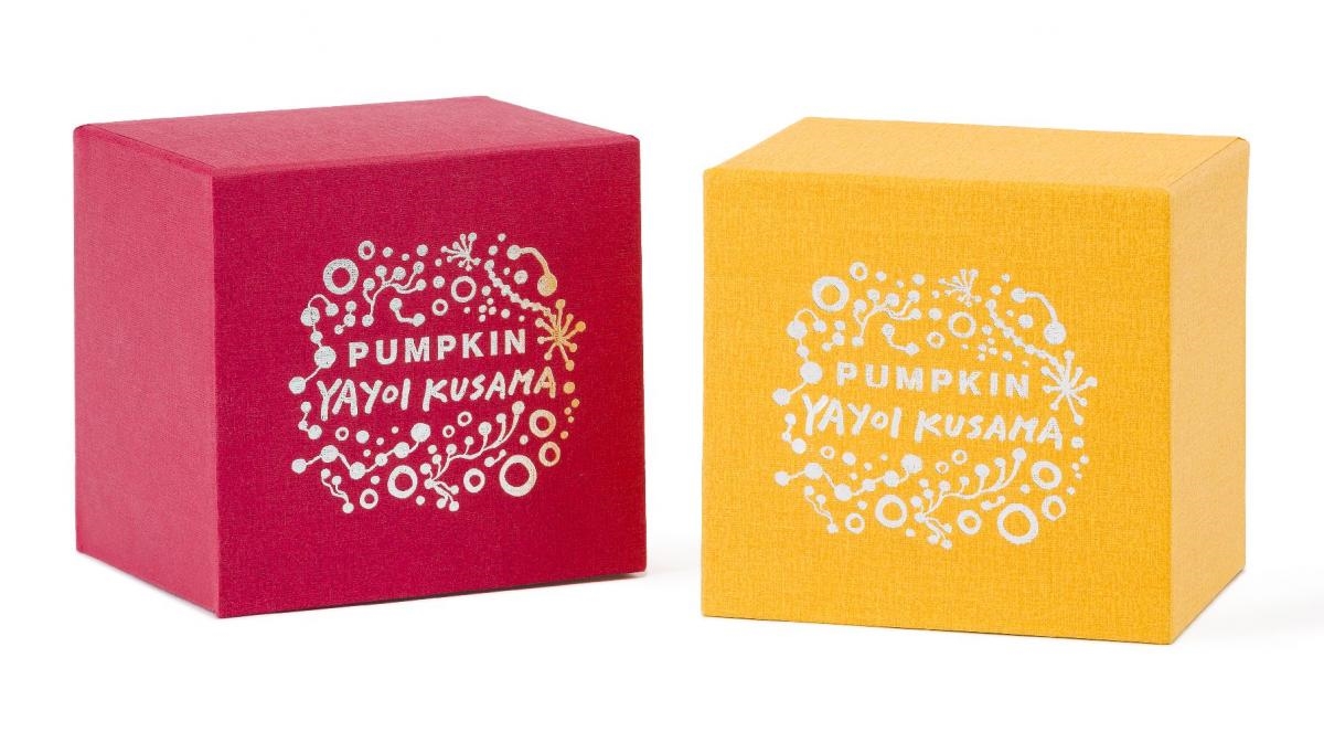 A pair of stylized pumpkin sculptures covered in contrasting dot patterns.