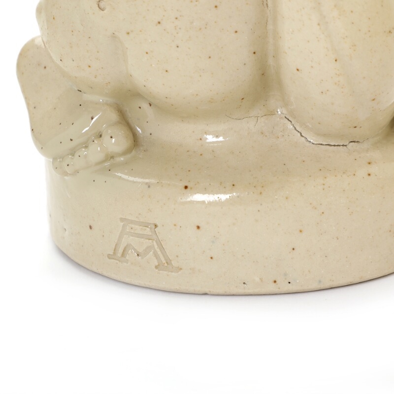 Artwork by Arno Malinowski, Stoneware figure group modelled in the shape of a cherub with dolphin and cornucopia, Made of Stoneware