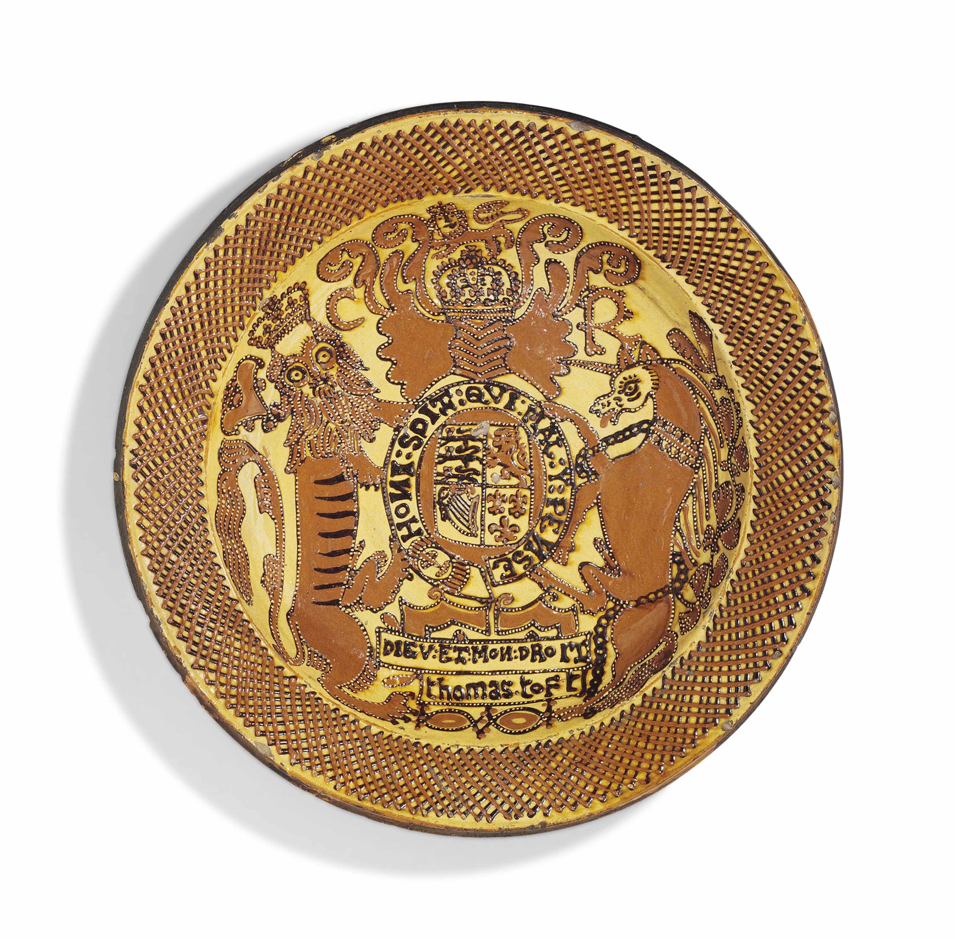 Artwork by Thomas Toft, A STAFFORDSHIRE SLIPWARE ‘ROYAL ARMS=’ CHARGER, Made of cream coloured