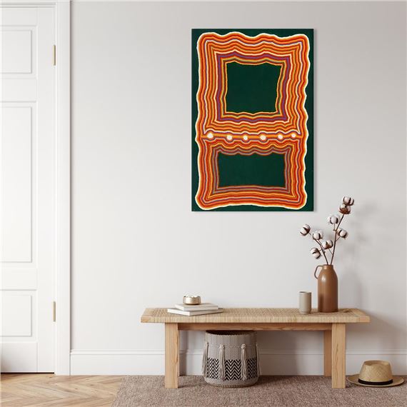 A minimalist interior scene featuring a colorful abstract wall art piece above a wooden console table.