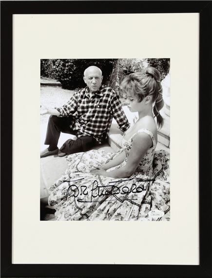 A signed b/w photograph of the French actress and model Brigitte Bardot in the company of Pablo Picassso (1881–1973) by Jérôme Brierre