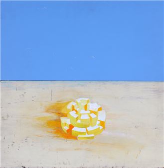 A geometric, blocky sculpture in yellow and white sits on a textured surface against a vast blue background.