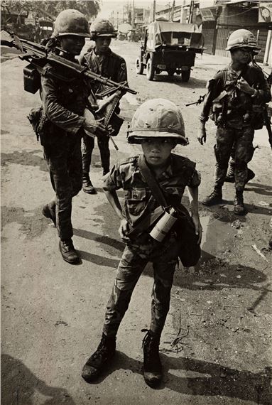 Called "Little Tiger" for killing two "Vietcong women cadre" - his mother and teacher, it was rumored. by Philip Jones Griffiths, 1968