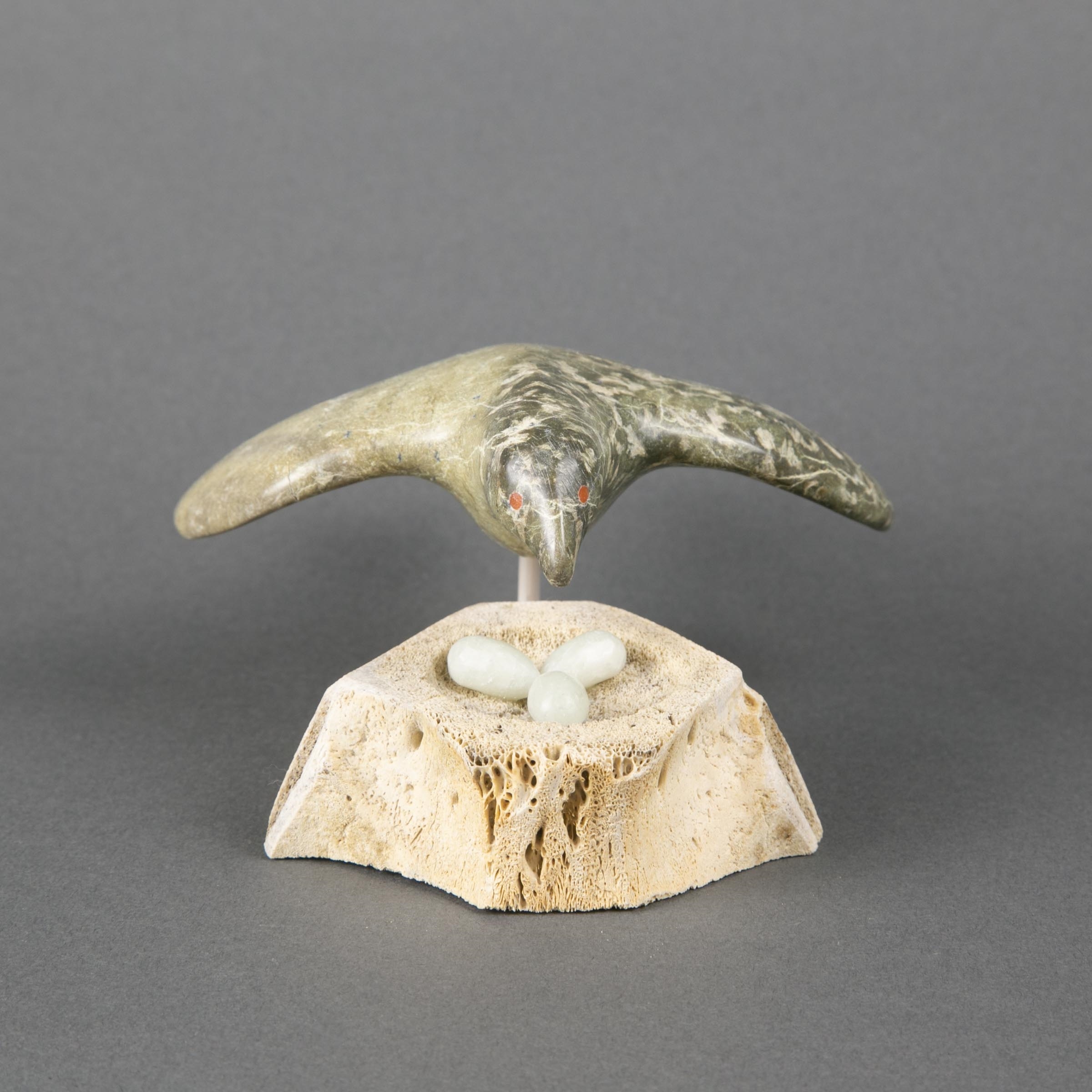 Artwork by Simeonie Amagoalik, BIRD PROTECTING HER EGGS, Made of bone, stone