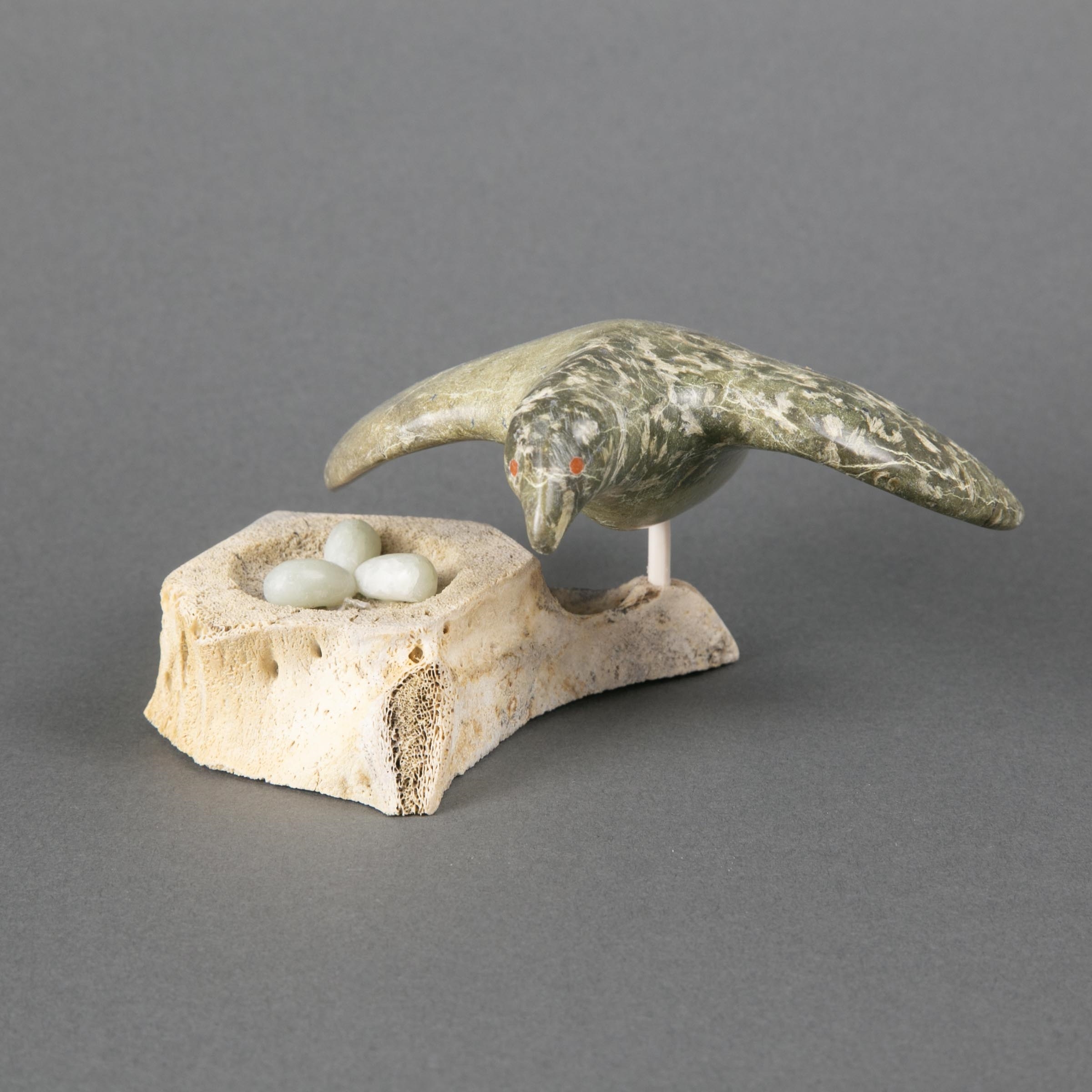 Artwork by Simeonie Amagoalik, BIRD PROTECTING HER EGGS, Made of bone, stone