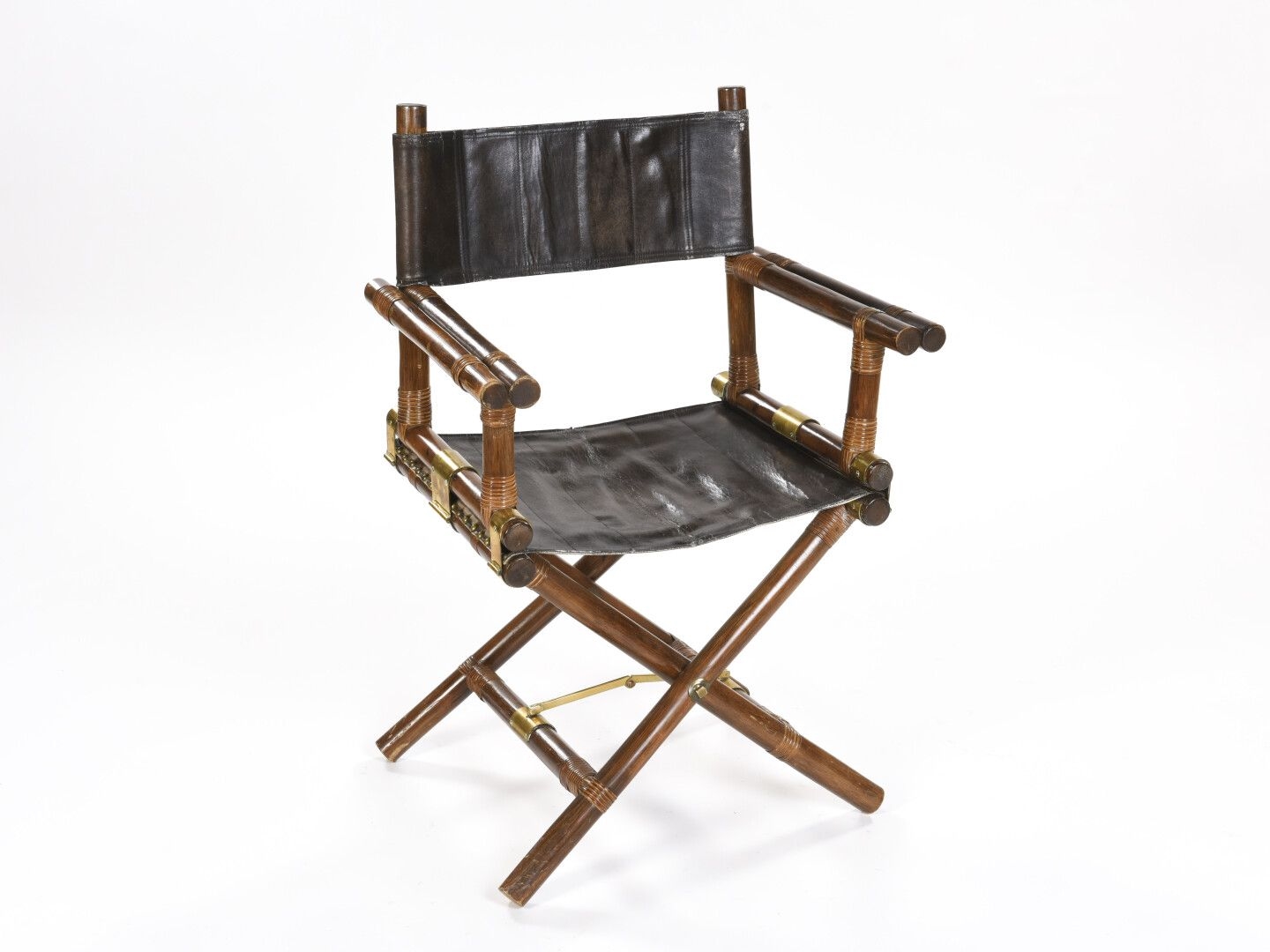 Artwork by John Mc Guire, Folding armchair, Made of gilt metal, the seat and back in dark brown leather with saddle stitching