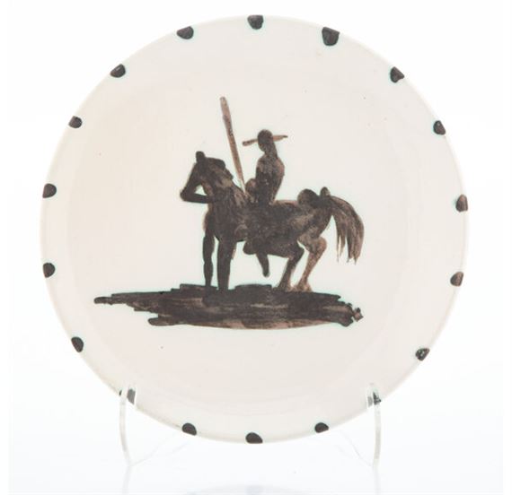 A plate with a man on a horse and a man riding a horse.