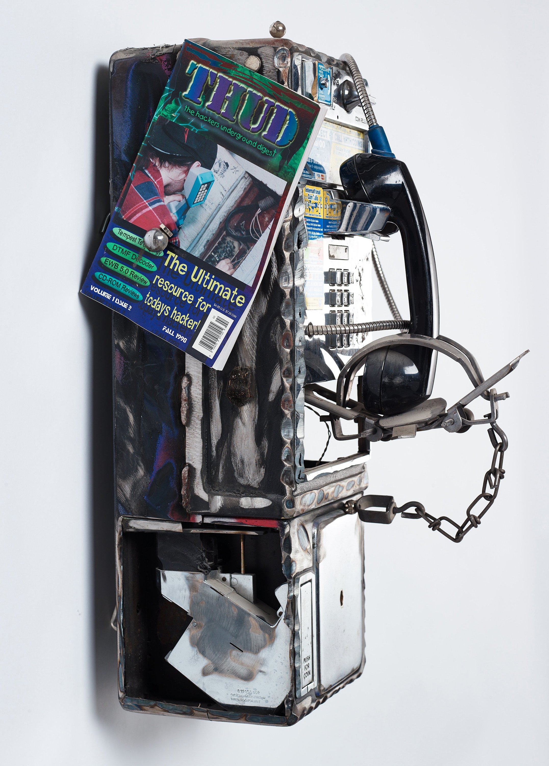 Artwork by Jason Matthew Lee, BRUTEFORCEPHREAK: thud, Made of Welded payphones, magnets, payphone dust, duct tape, small mammal trap, thud magazine