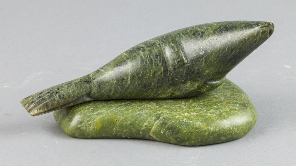 Artwork by Tukiki Manomie, a green stone carving of a seal, Made of green stone