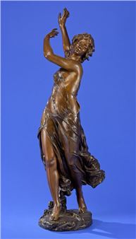 A bronze sculpture of a female figure in a dynamic, dancing pose.