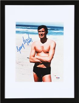 A signed colour still photograph of the Australian actor George Lazenby (b. 1939) in his role as James Bond in the motion picture “On Her Majesty's Secret Service” from 1969 - Michael Reed