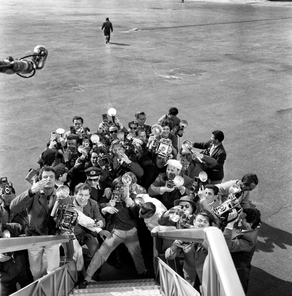 Paparazzi at the airport on the set of Federico Fellini's film "La Dolce Vita", 1960 by Pierluigi Praturlon, 2021
