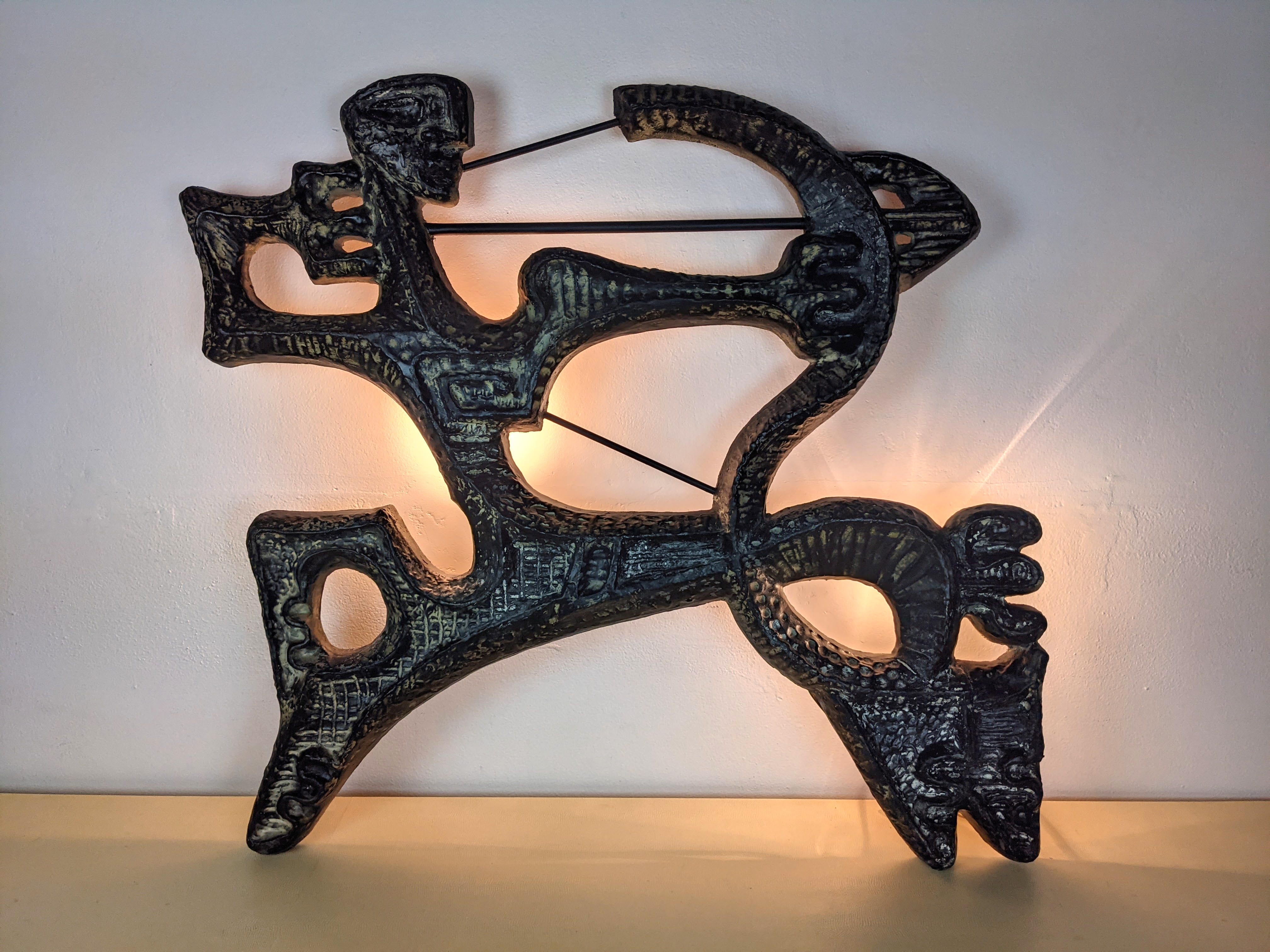 Artwork by Frederick Weinberg, Figural Archer Wall Sculpture, Made of Plaster form painted black with gold highlights.