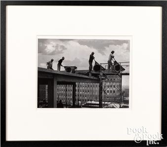 Large press photograph of four men with wheelbarrows atop a partially constructed building - Richard Stacks