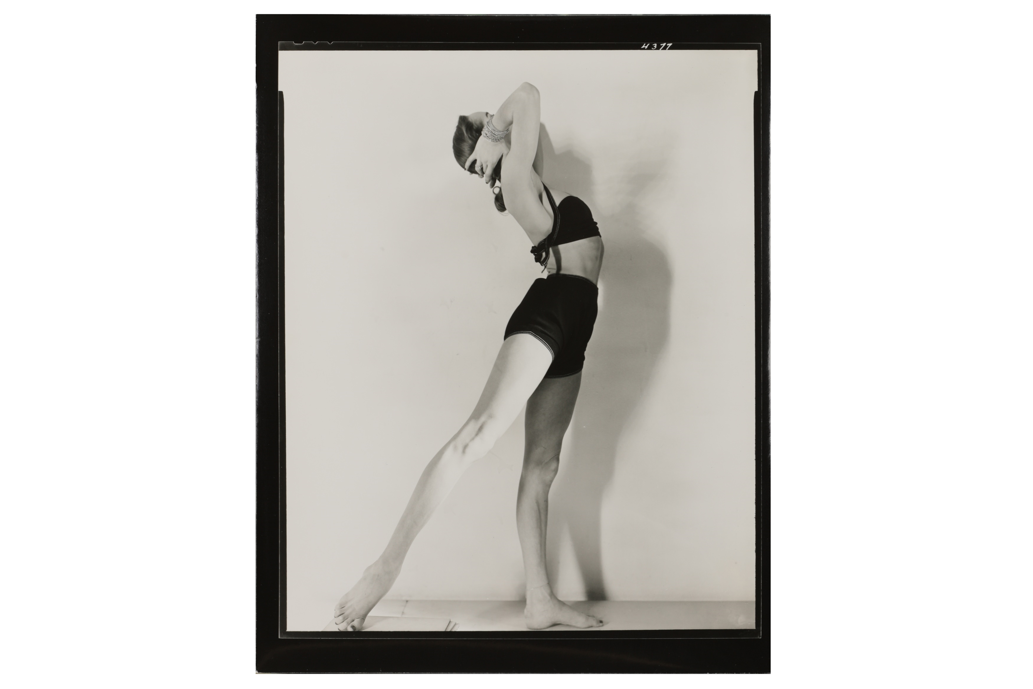 A BALLERINA POSING FOR A FASHION PHOTOSHOOT by Martin Munkacsi