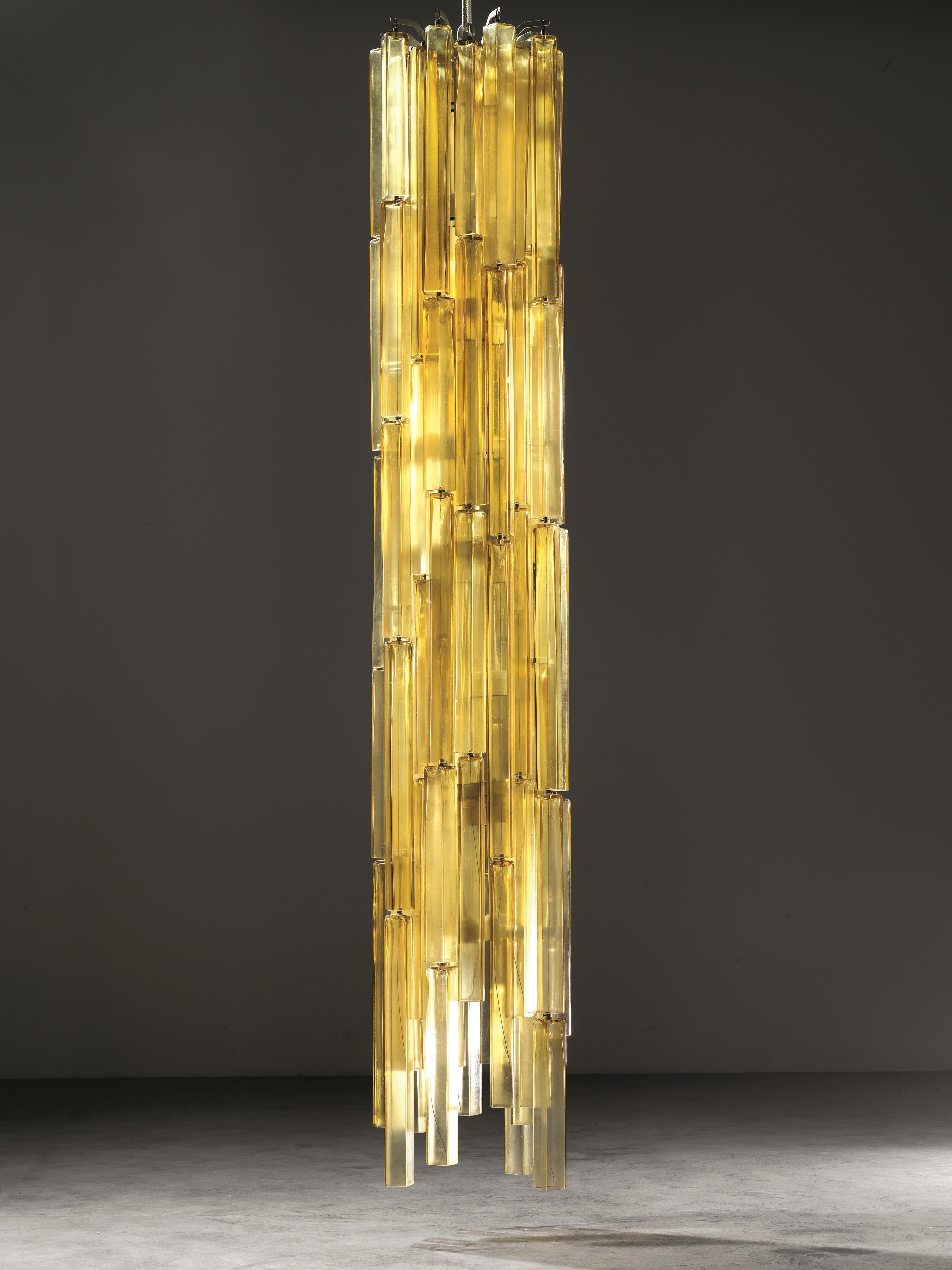 Artwork by Vinicio Vianello, LAMPADARIO, Made of metal with blown glass pendants in shades of amber