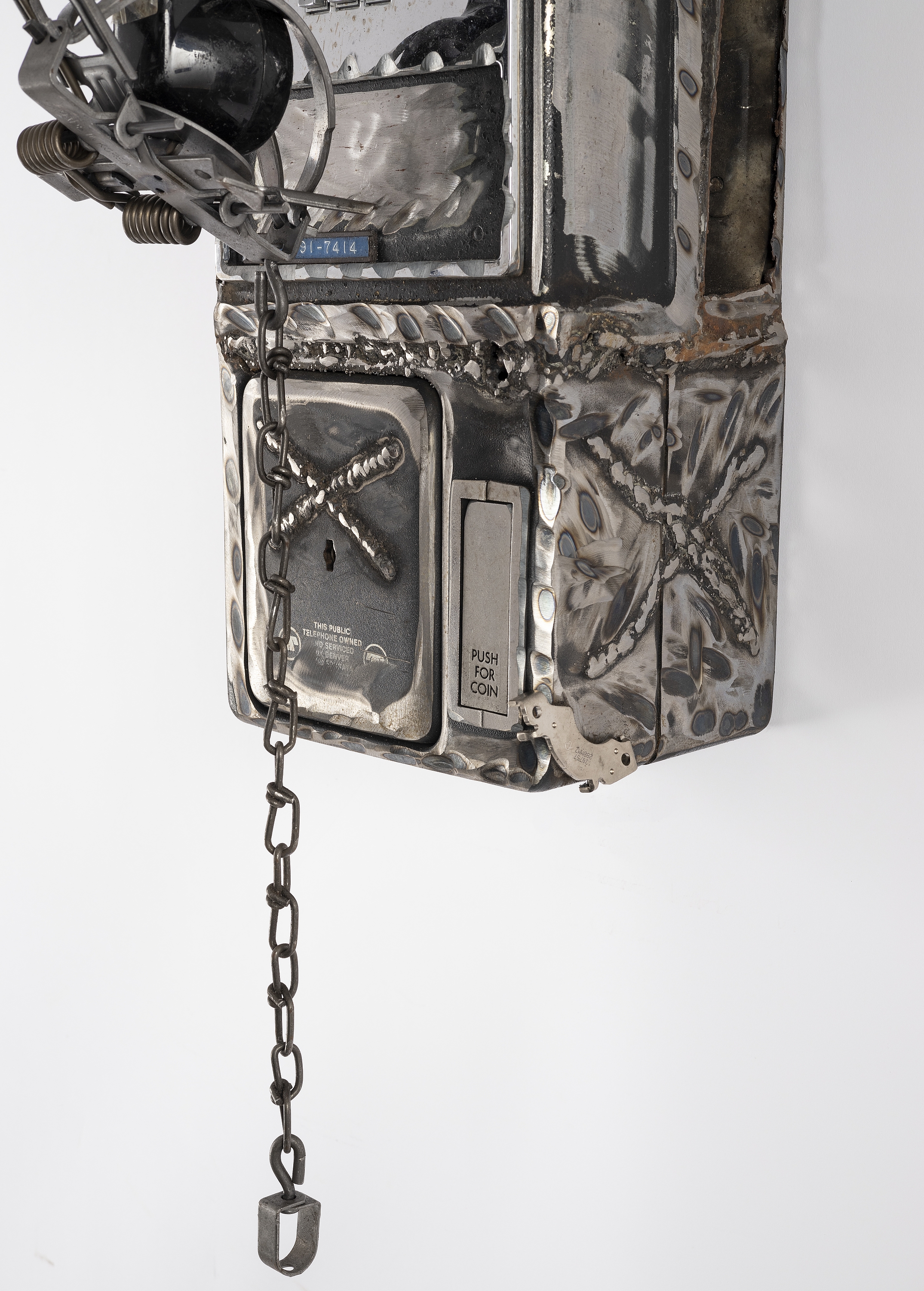 Artwork by Jason Matthew Lee, BFP:time791-7414, Made of hardrive magnets, animal trap, on cut and welded payphones