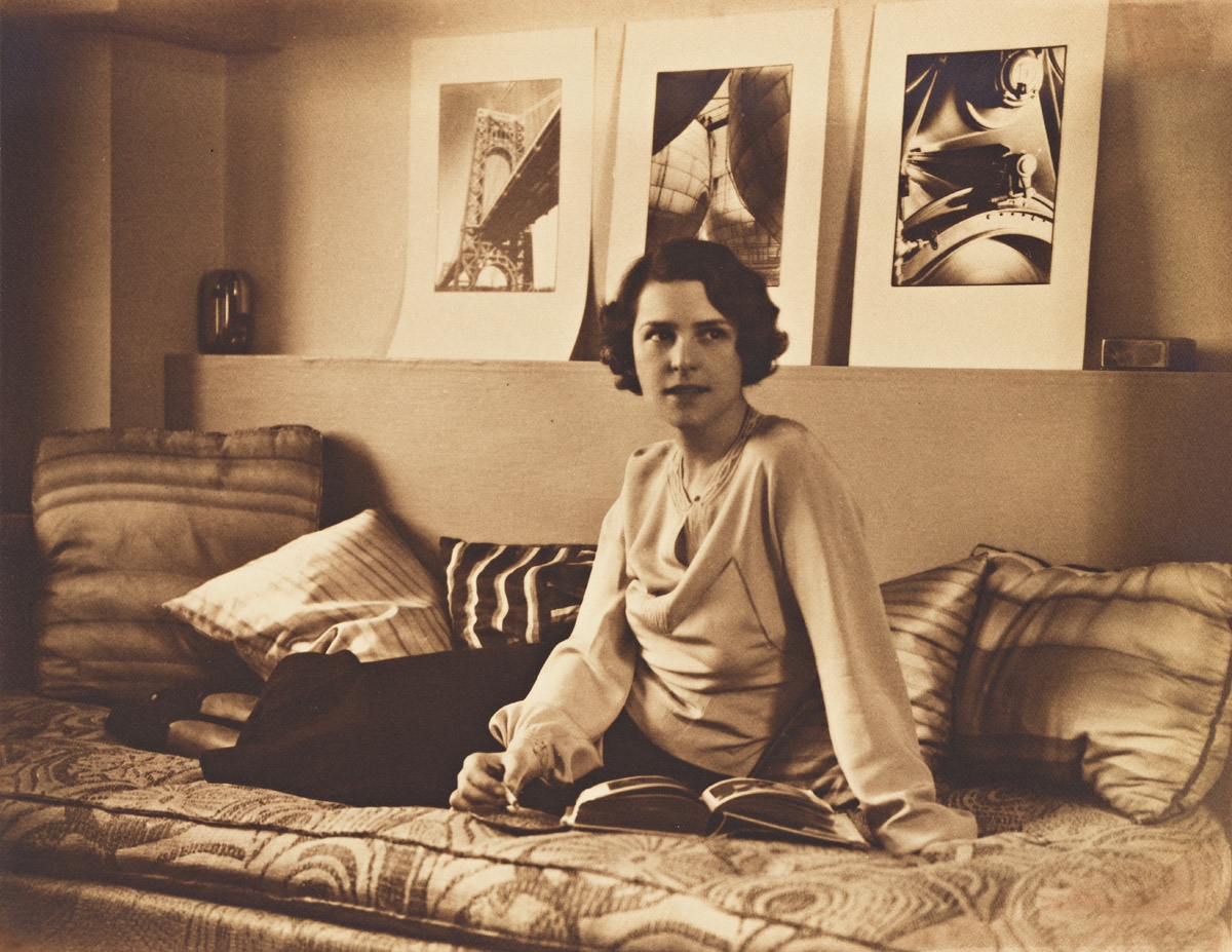 Artwork by H. Richardson Cremer, Portrait of Margaret Bourke-White with her photographs behind her., Made of Silver print