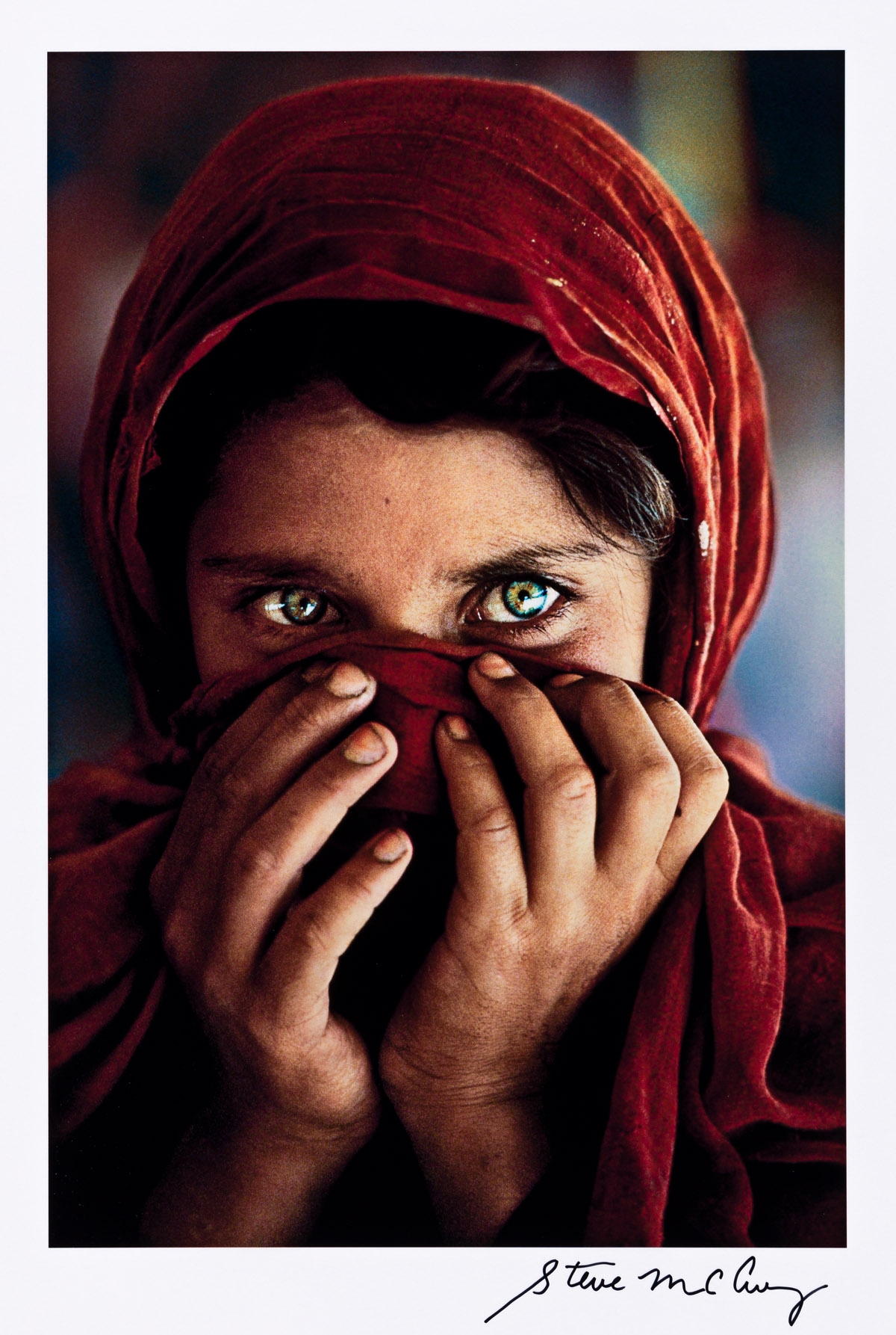 Afghan Girl (Sharbat Gula) hiding her face, Peshawar, Pakistan. by Steve McCurry, printed 1990s