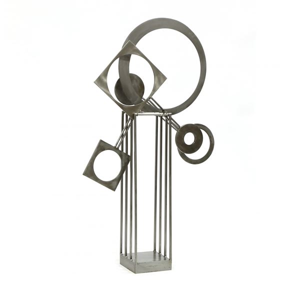 A minimalist metal sculpture featuring geometric shapes suspended over a vertical grid base.