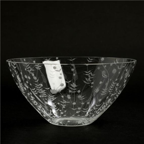 A clear glass bowl with florale engravings