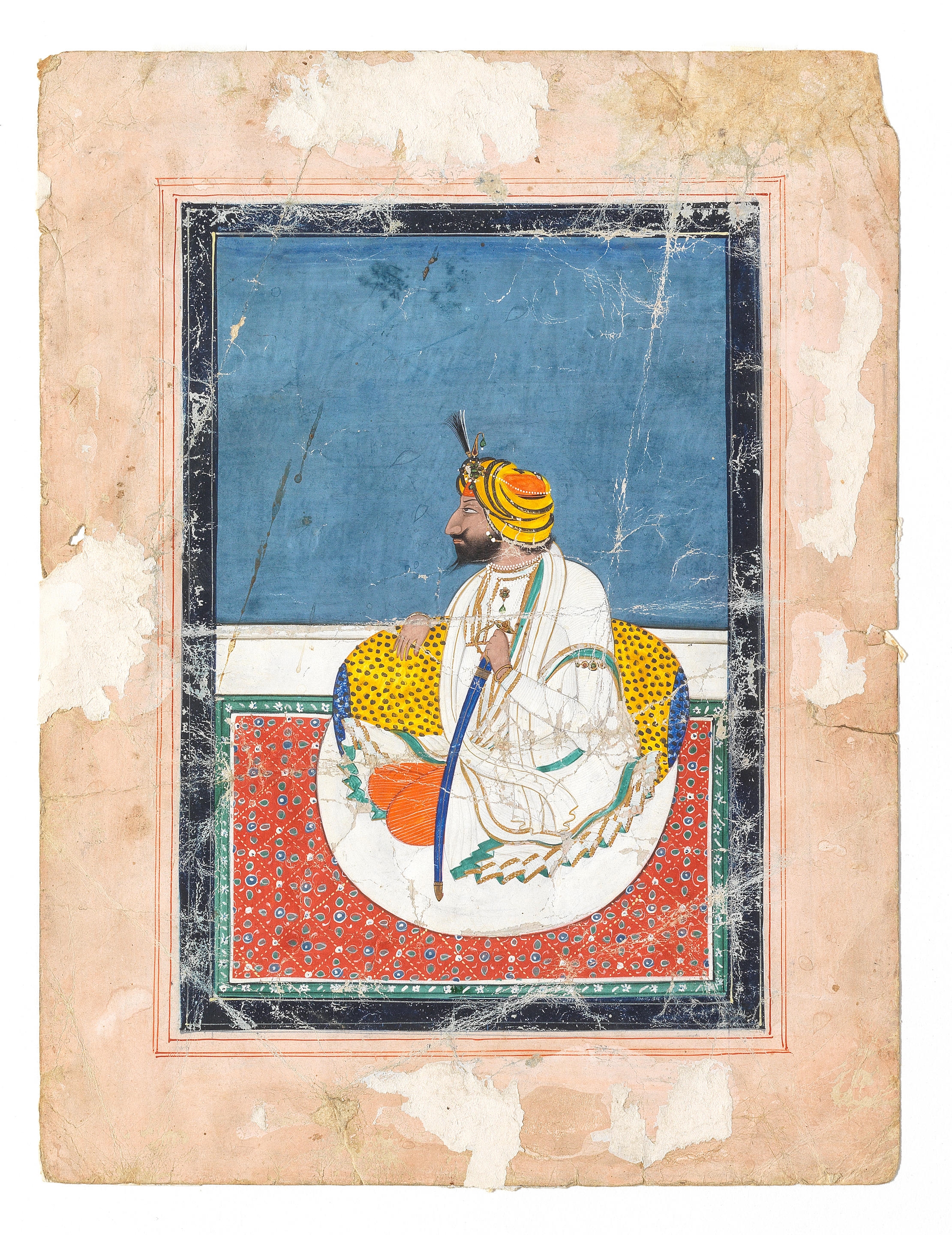 Maharajah Gulab Singh (1792-1857) seated holding a sword against a bolster on a terrace