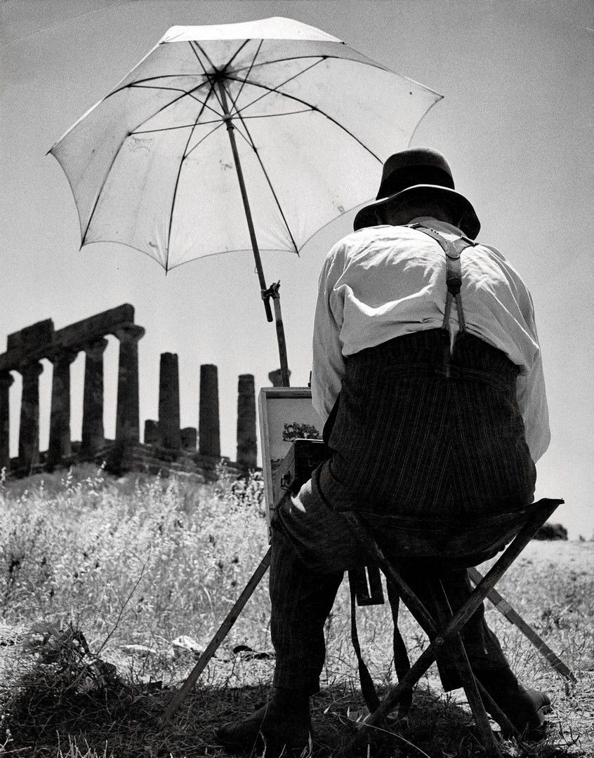 A painter in front of the temple of Heracles, Agrigento by Herbert List, 1952