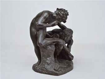 A bronze sculpture of a muscular figure leaning over another seated figure.