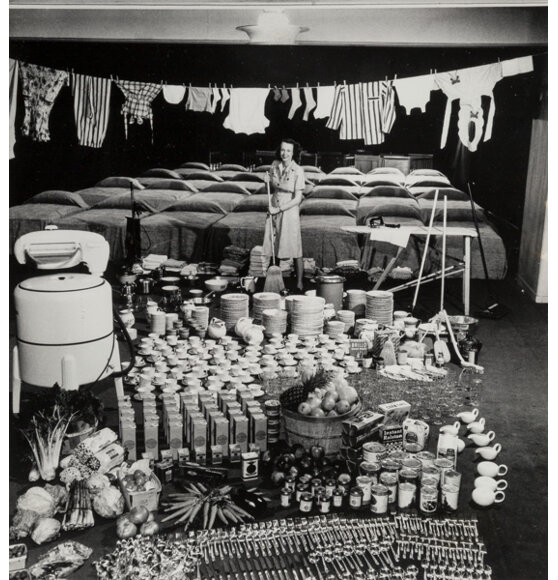 Housewife Marjorie McWeeney amid symbolic display of her week's housework by Nina Leen, 1947
