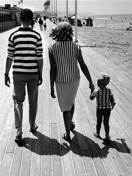 Family walking on the boards of Deauville by René Maltête, circa 1970