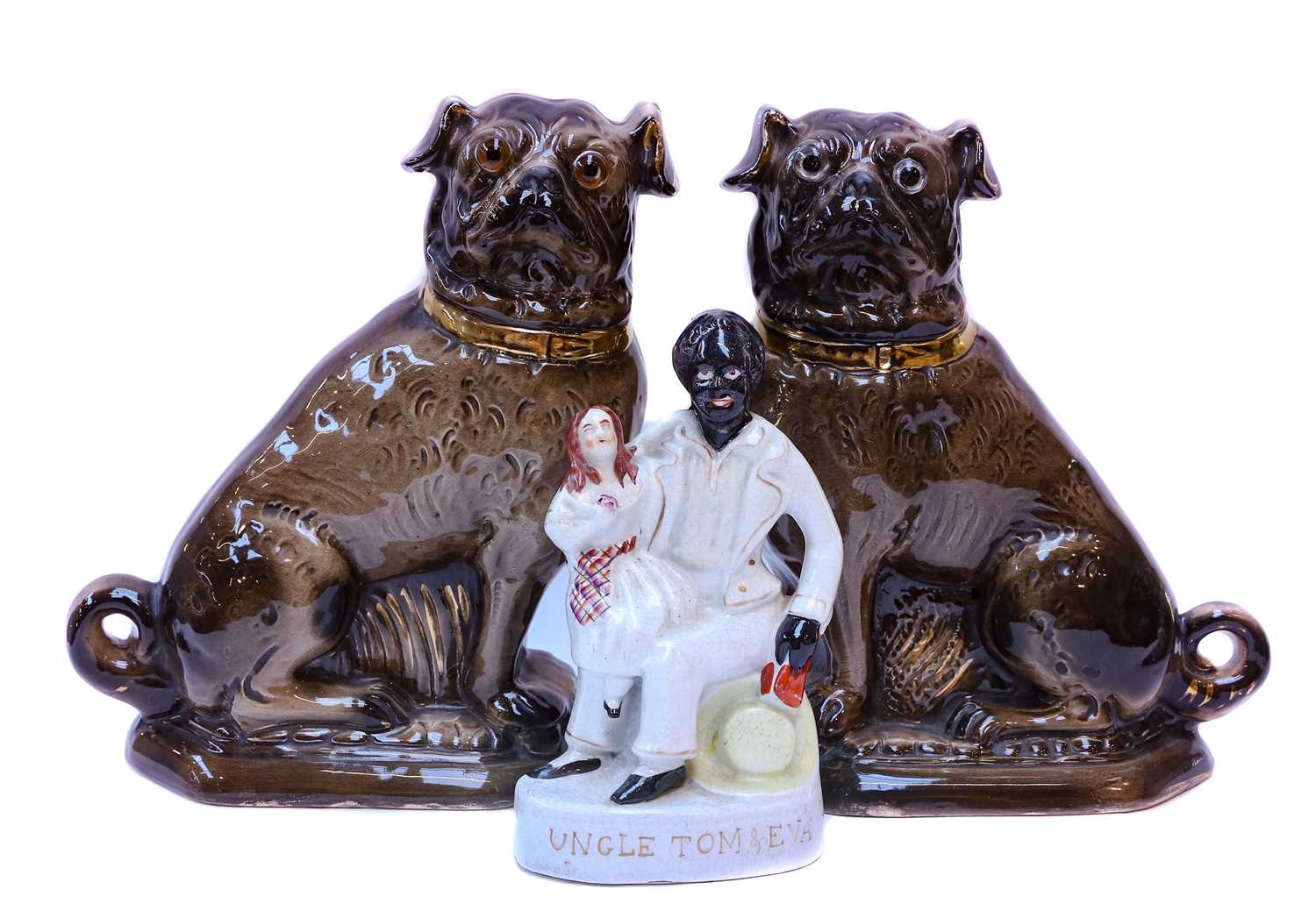 A pair of Victorian Bo'ness pottery models of seated Pug dogs; together with a Staffordshire group of 'Uncle Tom & Eva' by Staffordshire