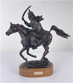 A bronze sculpture of a warrior on horseback holding a sword.