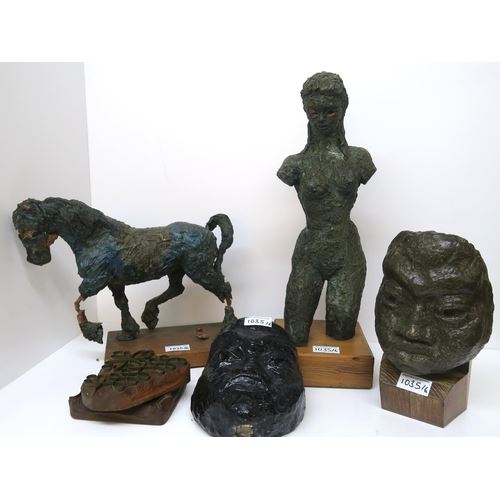 A FEMALE FIGURE, A HORSE AND TWO PAPIER MACHE MASKS ON STANDS, together with two printing blocks