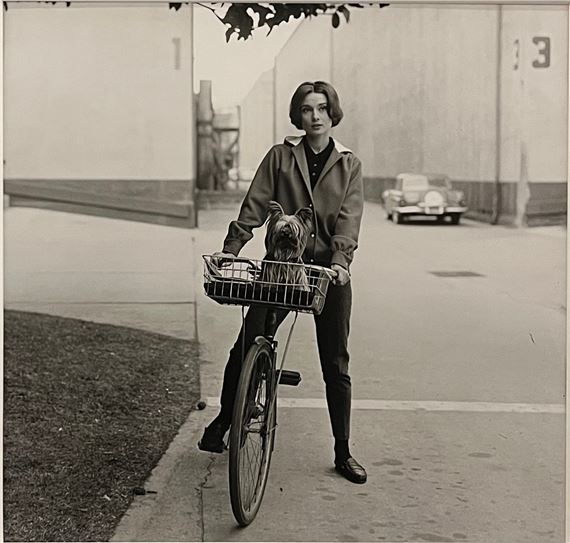 Audrey Hepburn on bike with her dog ‘Famous’ at Paramount Studios by Sid Avery, 1957