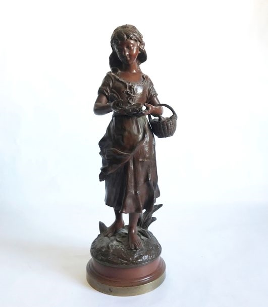 Artwork by Charles Anfrie, Young girl with basket reading, Made of bronze with brown patina