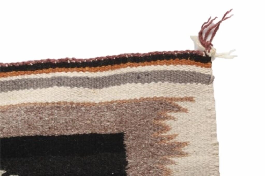 Artwork by Mae Benally, Navajo Eye Dazzler Crownpoint rug, Made of Dyed colors of light brown, black, grey, heathered grey, and cream set to a black field.