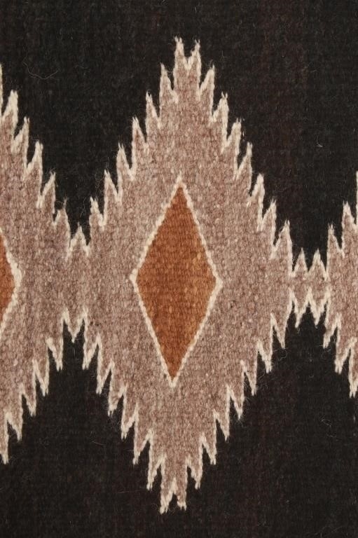 Artwork by Mae Benally, Navajo Eye Dazzler Crownpoint rug, Made of Dyed colors of light brown, black, grey, heathered grey, and cream set to a black field.