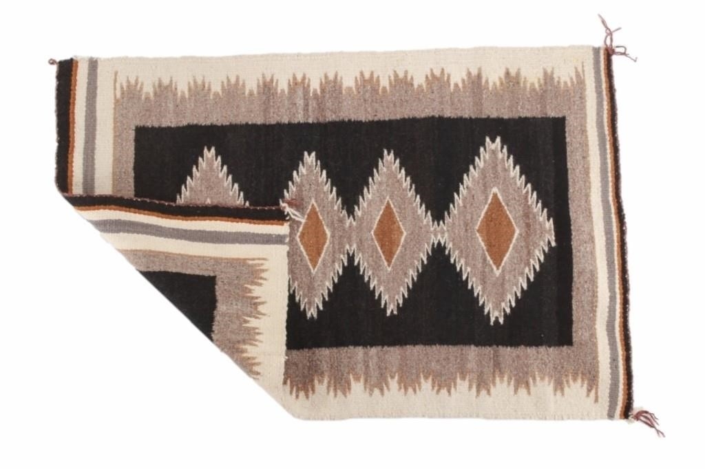 Artwork by Mae Benally, Navajo Eye Dazzler Crownpoint rug, Made of Dyed colors of light brown, black, grey, heathered grey, and cream set to a black field.